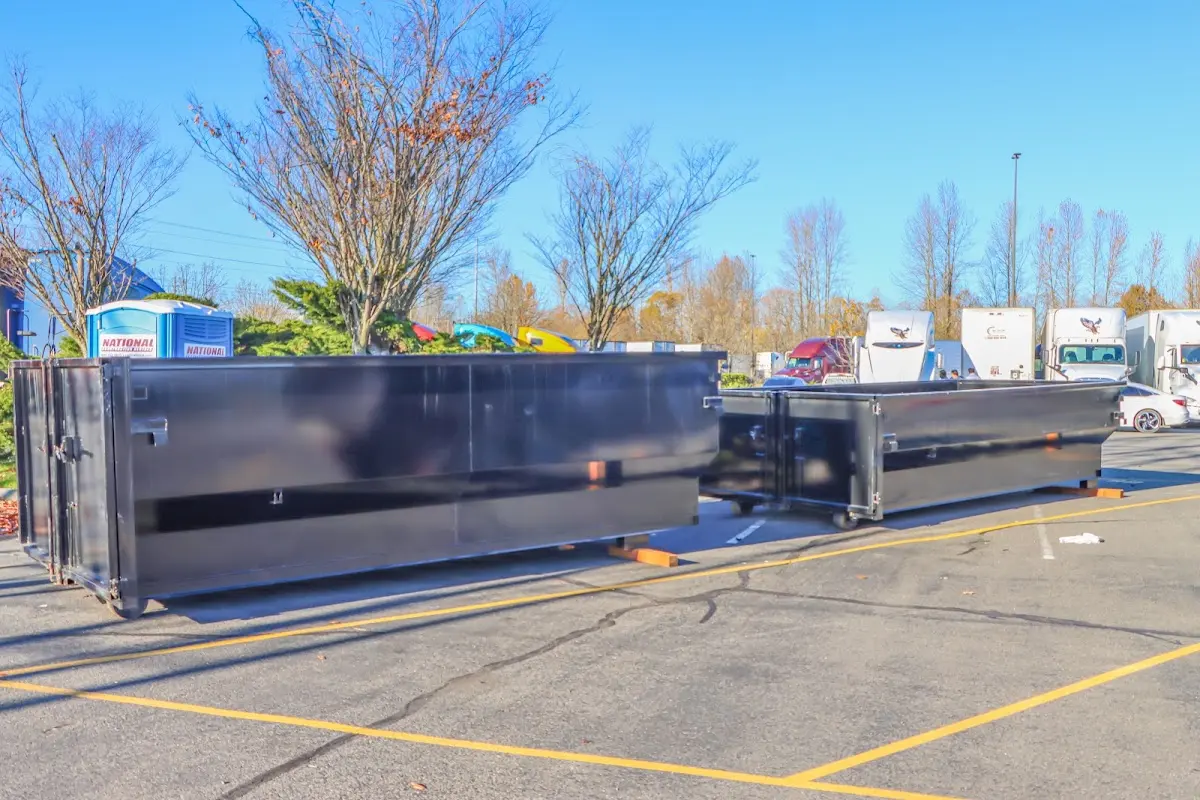 Professional dumpster rental service with roll-off container on residential driveway in Branford